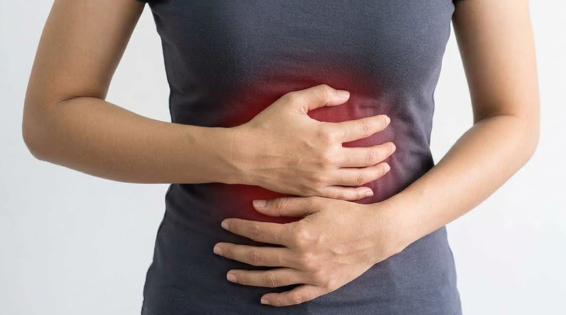 Woman holding her stomach in pain from digestive discomfort